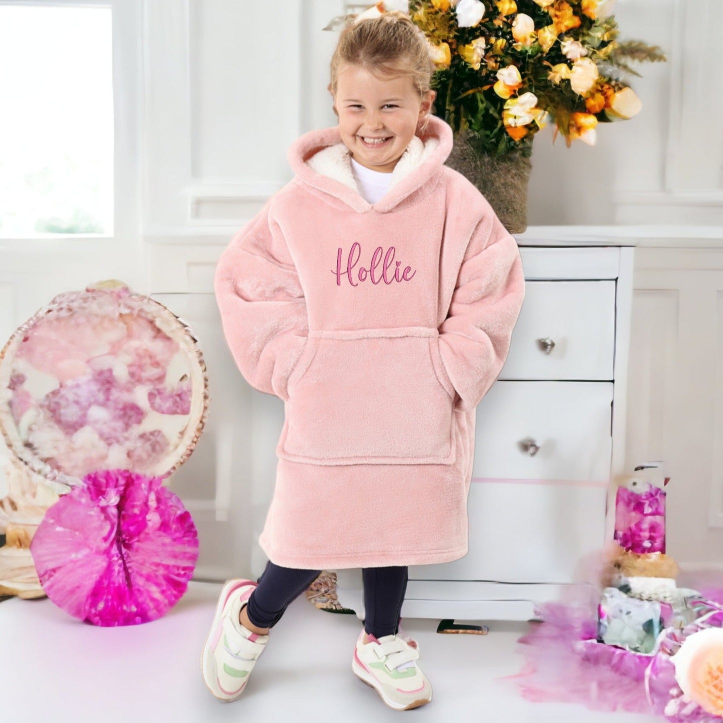 This is a luxury sherpa overside hoodie blanket. The hoodie is embroidered on the chest with a name in cursive font. Available in multiple colours for adults and children. Personalised christmas gift idea.