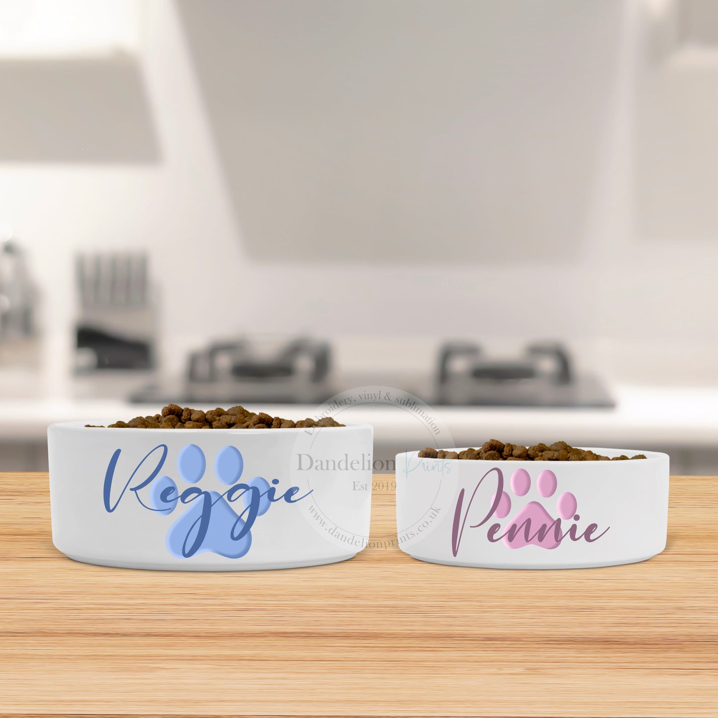 This is a white dog bowl available in two sizes. The bowl is printed with a blue or pink paw print and a pets name. These are great personalised pet items