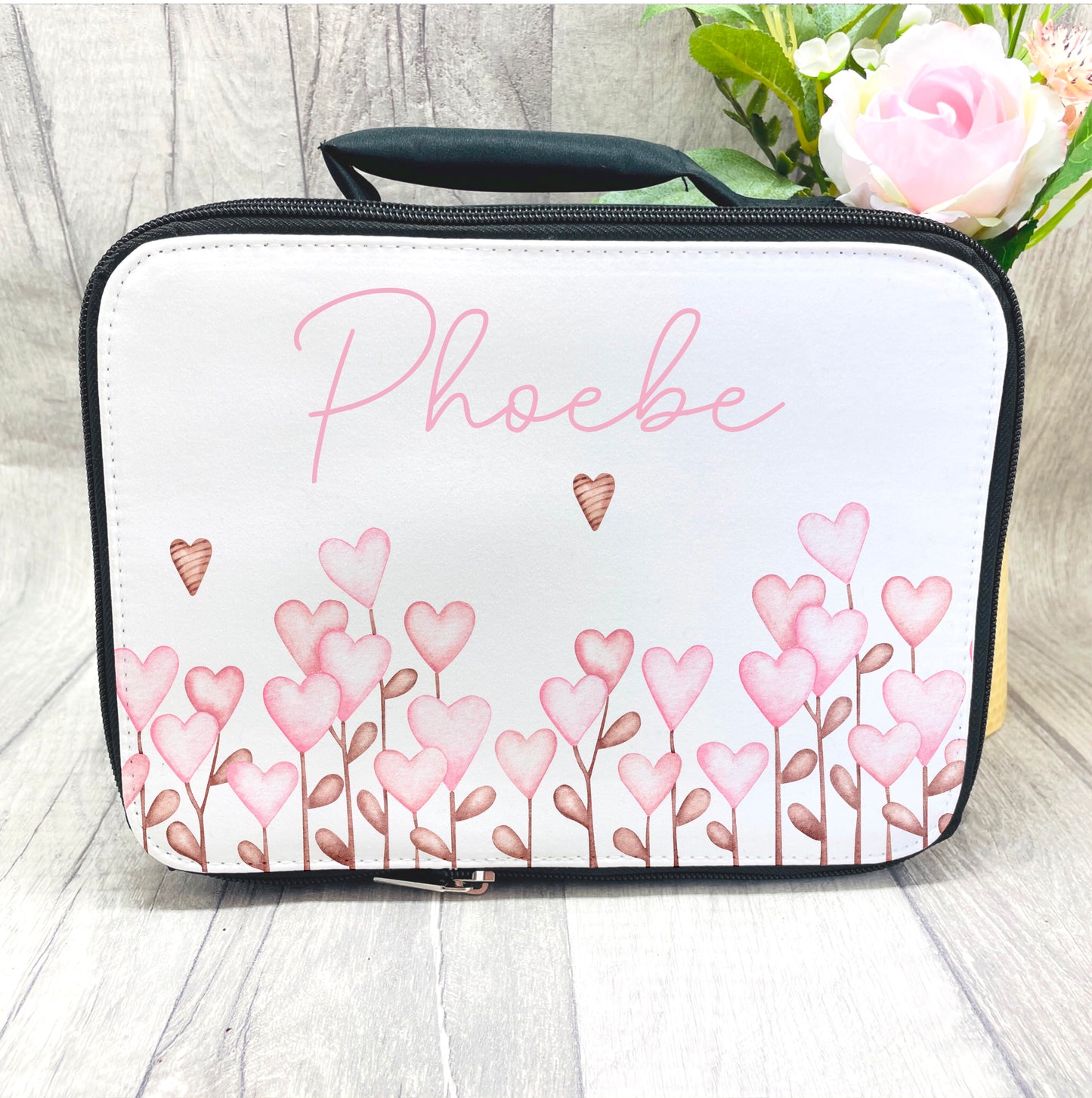 Pretty heart flowers all lined up across the bottom of this insulated lunch bag. These lunch bags are great for school or nursery with a name printed at the top