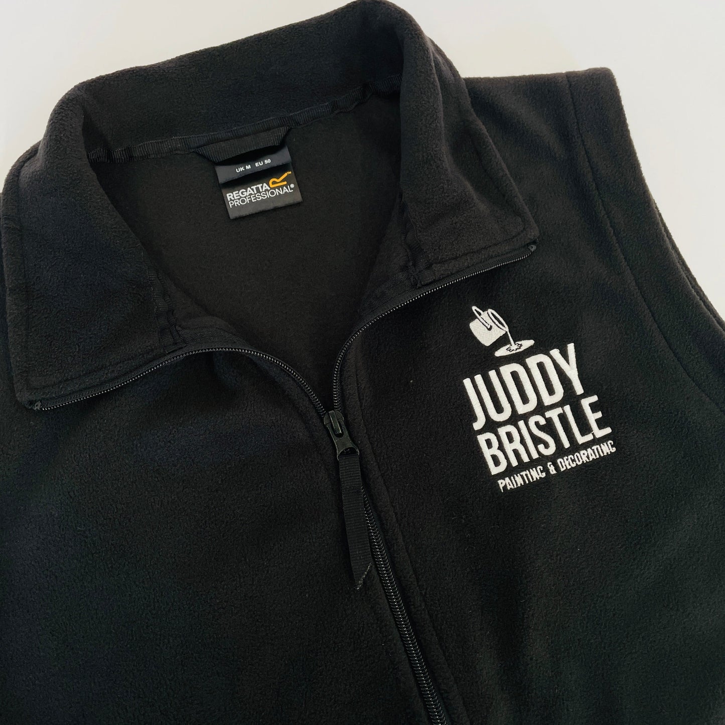 This is a black bodywarmer fleece gilet. The brand is regatta. These gilets are embroidered with your company logo.