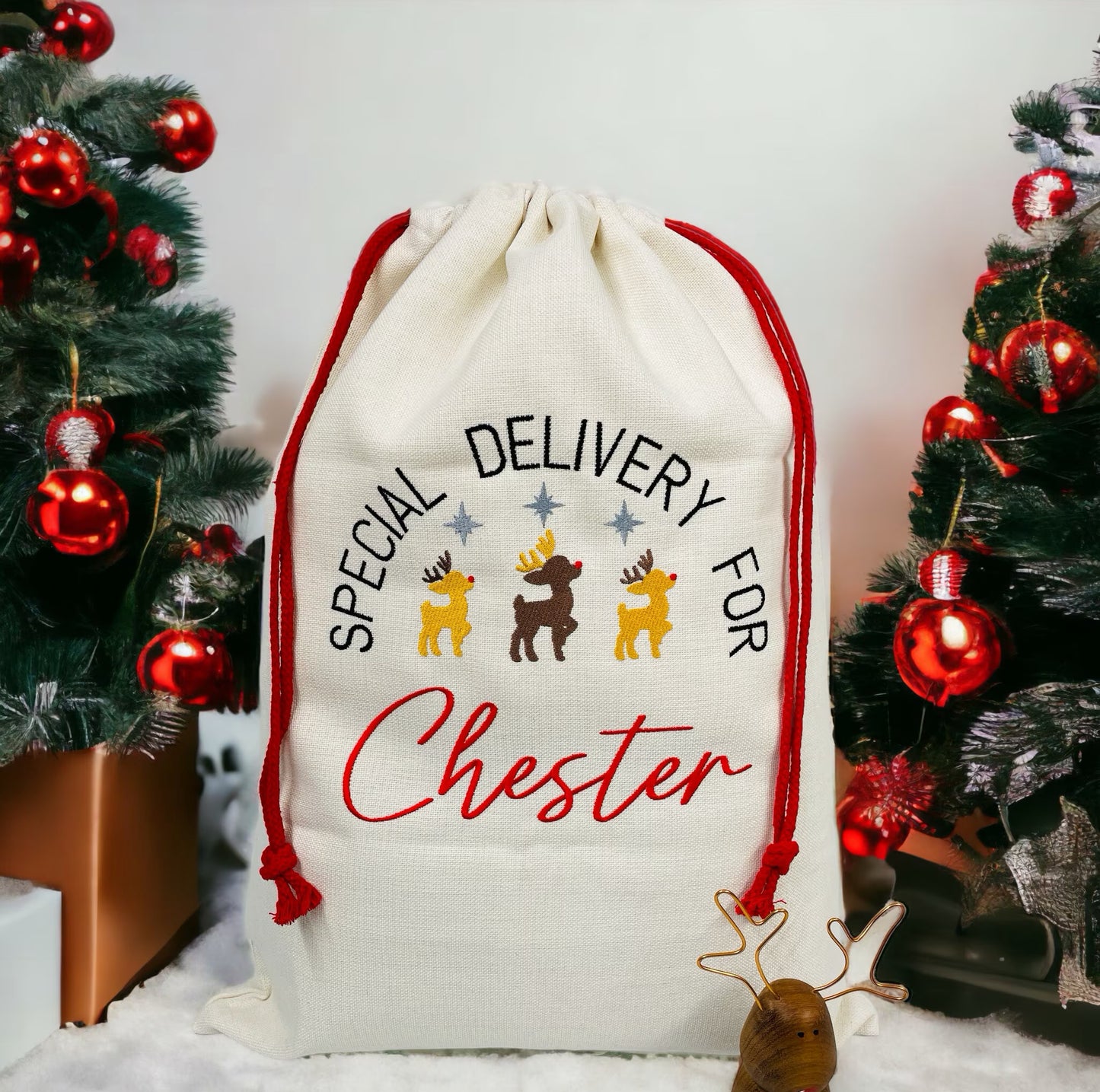 This is an extra large canvas santa sack. The sack is fully embroidered with a trio of reindeer. The text reads Special delivery for NAME. Childrens personalised sacks add to the magic of christmas. These have red pull strings to close the sack.