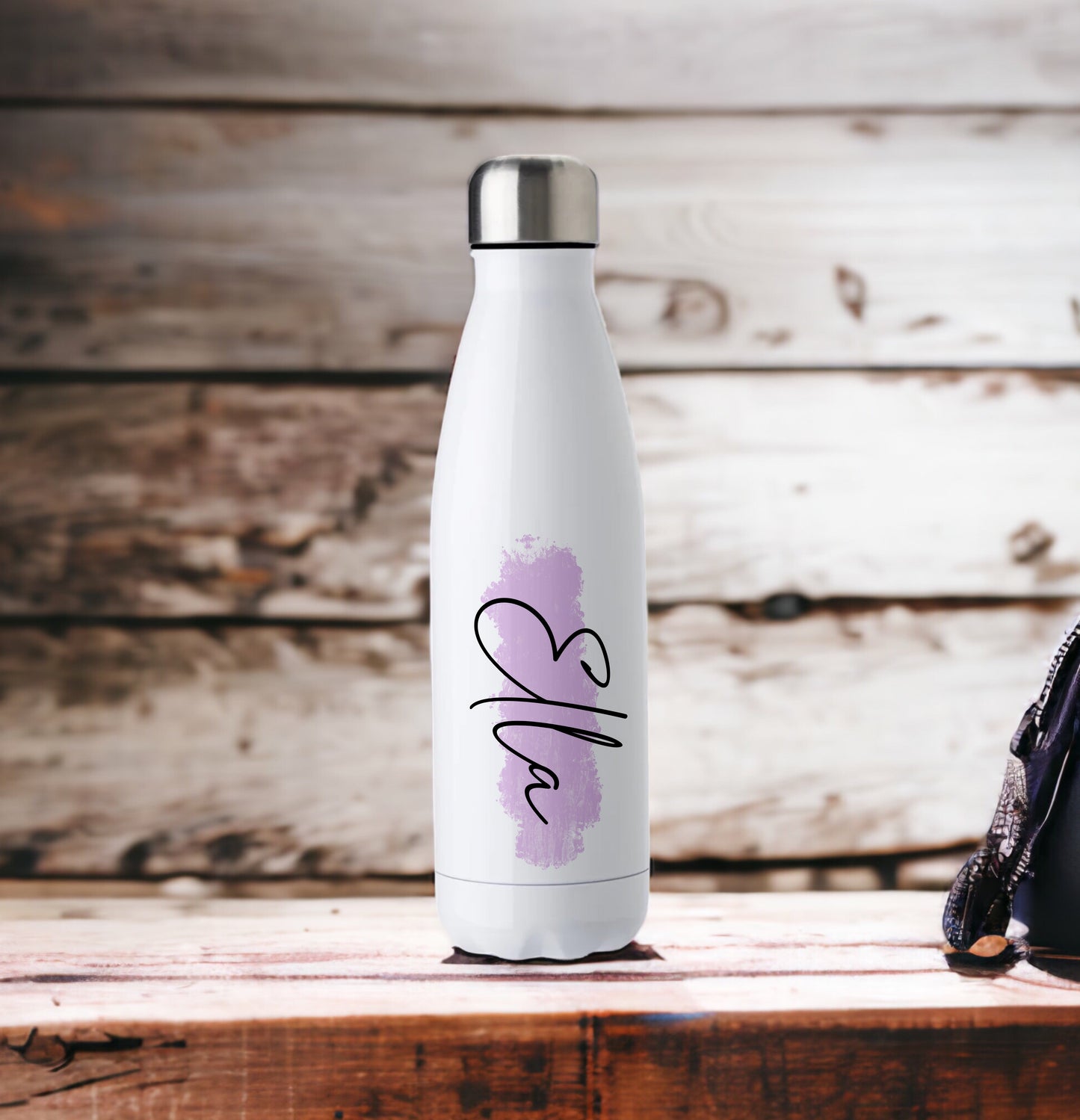 This is a white chill flask. It is designed to keep drinks cooler for longer. These flasks hold 500ml of liquid. Printed on the flask is a lilac watercolour splash and personalised with a name in black printed on top of it.