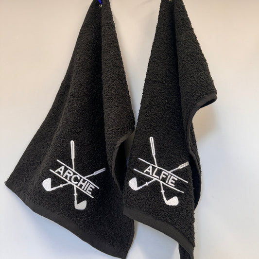 This is a black towel that clips onto your golf cart by a carabiner clip. The towel is embroidered with a golf club monogram and a name through the middle of it. Perfect for wiping those muddy clubs and golf balls down.