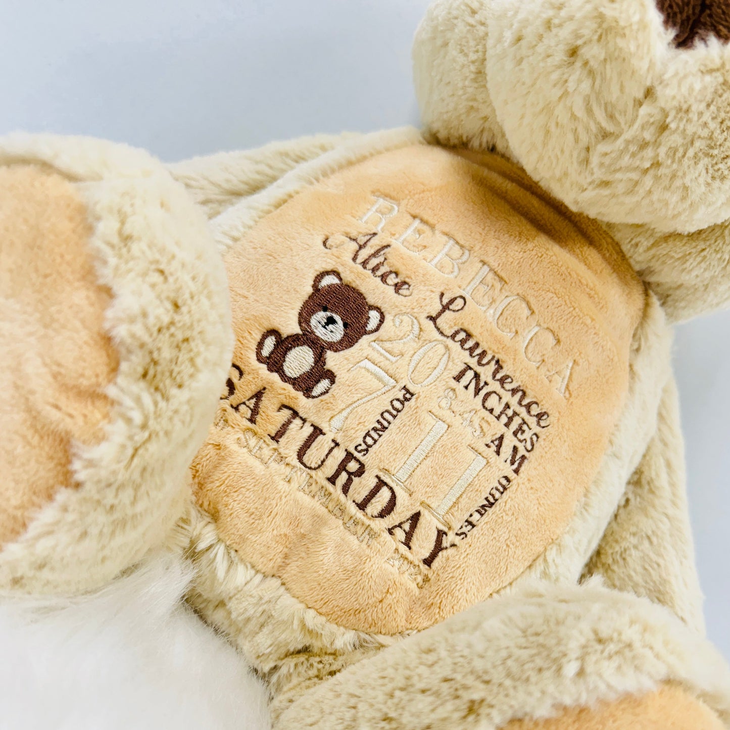 This is a gorgeous brown teddy bear. The bears belly is embroidered with a new babies birth details - date, name, weight etc. This is a lovely nursery accessory and a keepsake to cherish for years