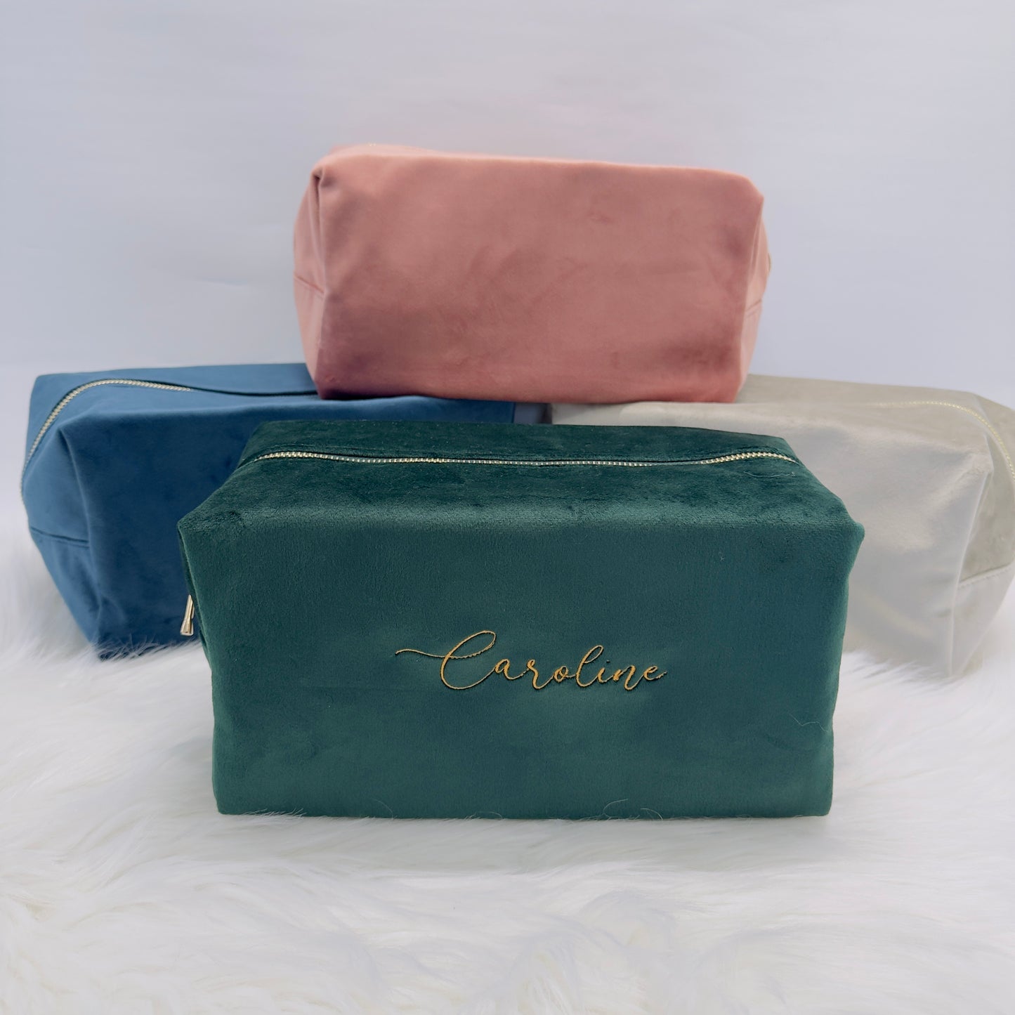 These velvet make up bags are incredibly useful for storing all of your beauty products.
Available in two sizes - the photos show all colours in large.
Medium - 11 x 23 x 11cm
Large - 14 x 28 x 14cm
We have four different colours to choose from - Blue, Emerald, Grey and Rose. These also match our smaller velvet bag if you are looking to create a set.
Each bag features a gold metal zip with your name embroidered in gold too.