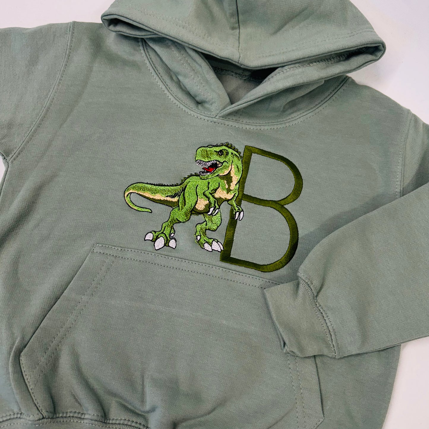Adorable Sage Kids Hoodie with T-Rex Dinosaur and Embroidered Initial Detail