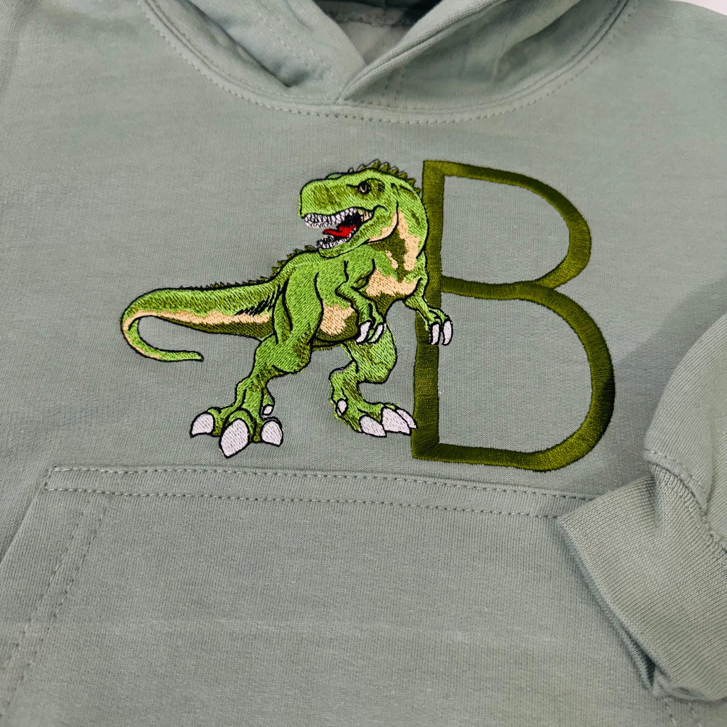 Adorable Sage Kids Hoodie with T-Rex Dinosaur and Embroidered Initial Detail
