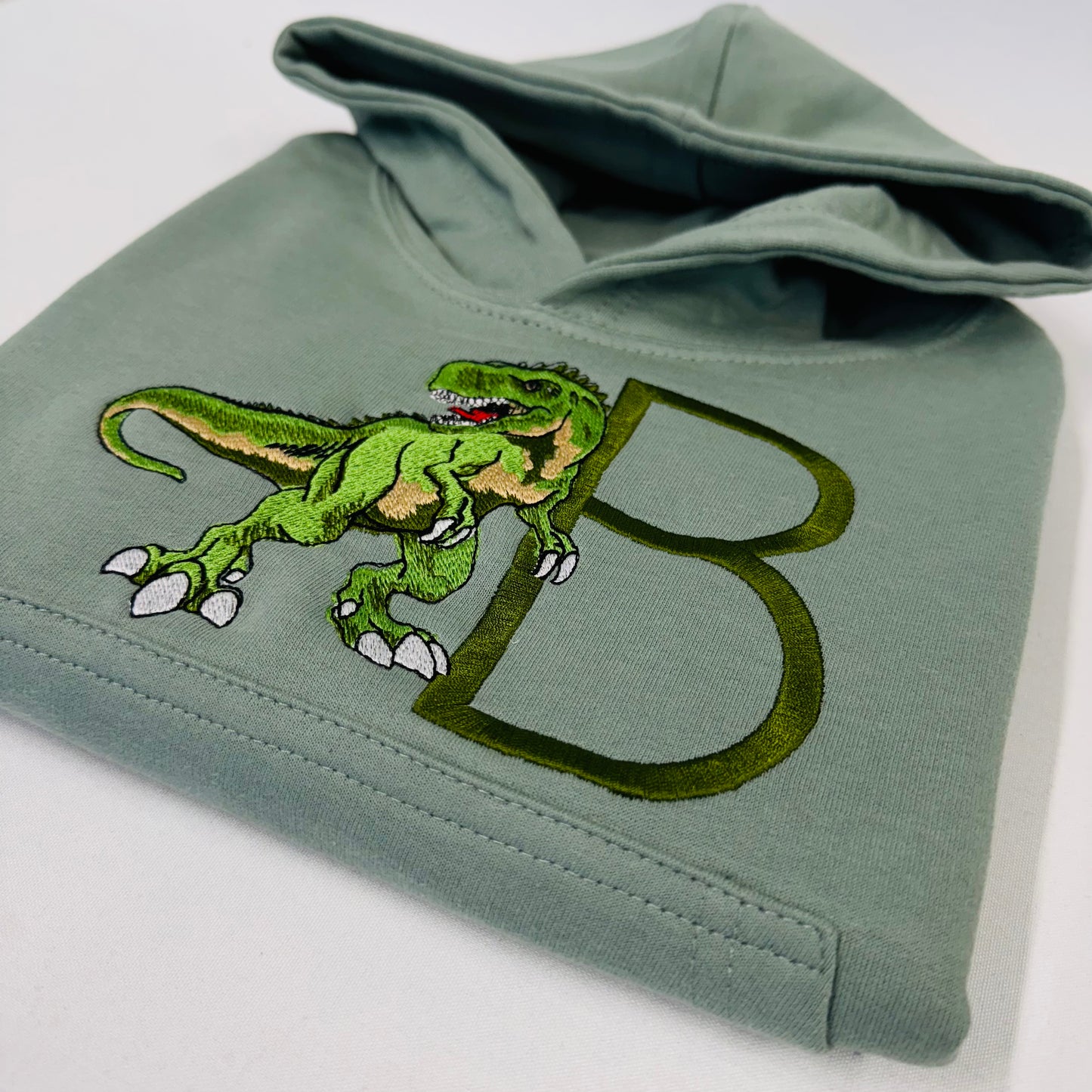 Adorable Sage Kids Hoodie with T-Rex Dinosaur and Embroidered Initial Detail
