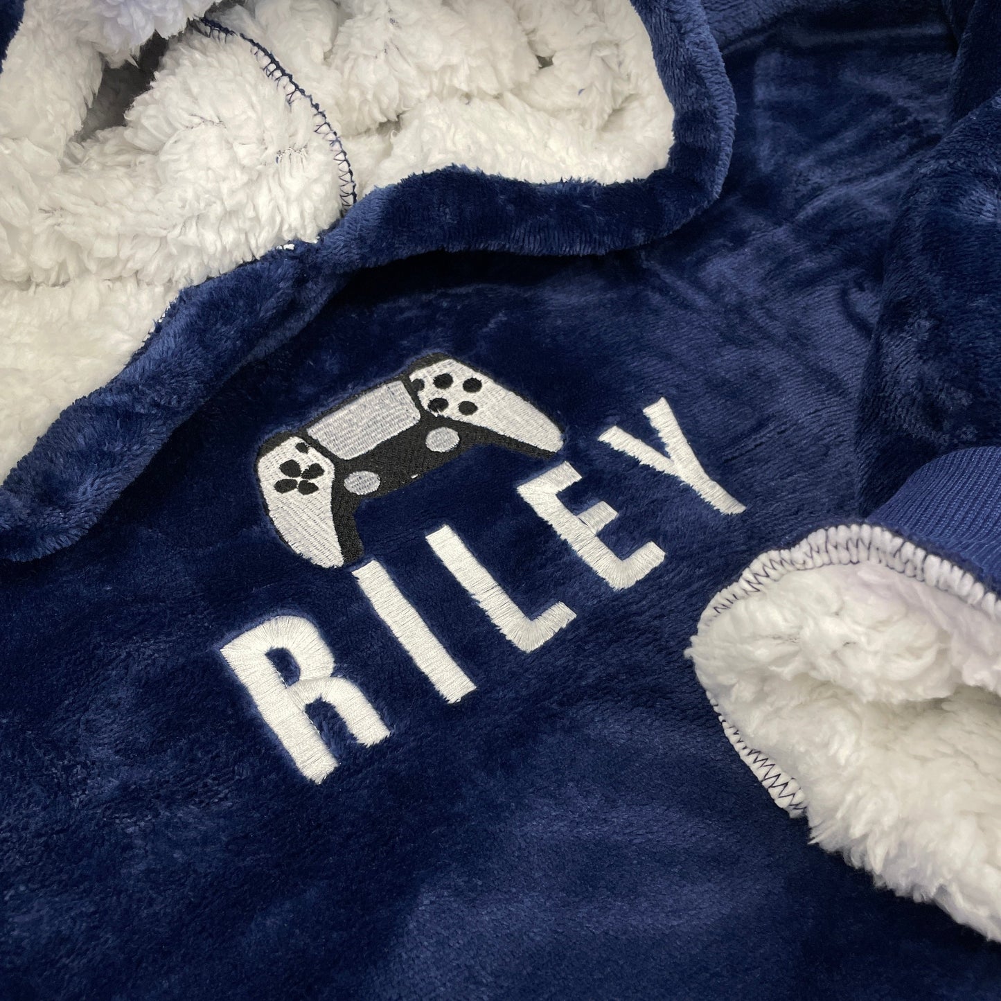 This is an oversized hoodie which is extremely warm and comfortable. Embroidered on the chest is a name and a picture of a gaming controller. Available in different colours this is a fantastic gift idea for all ages.
