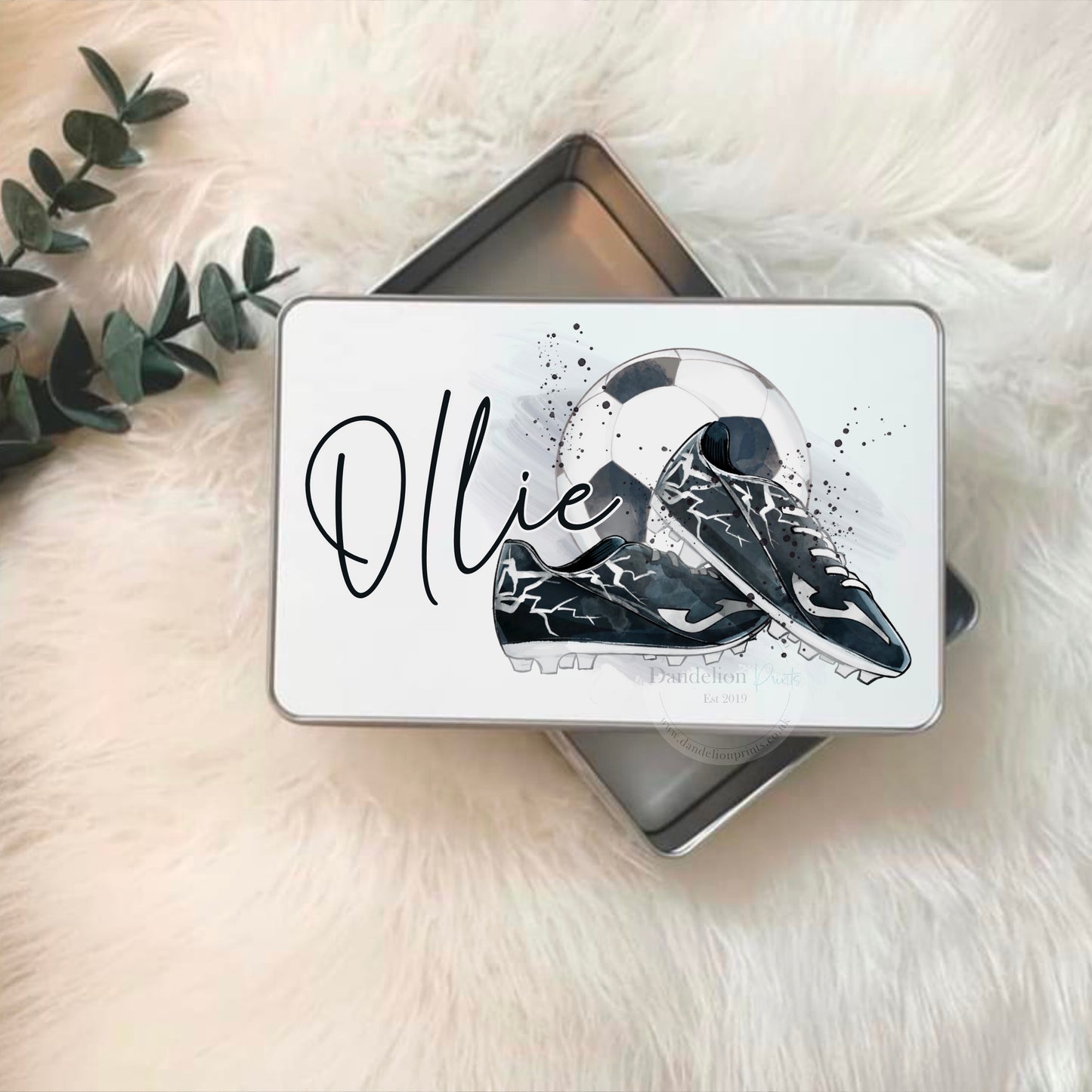 this is a white tin printed with a watercolour football and boots design. Personalised with a name too