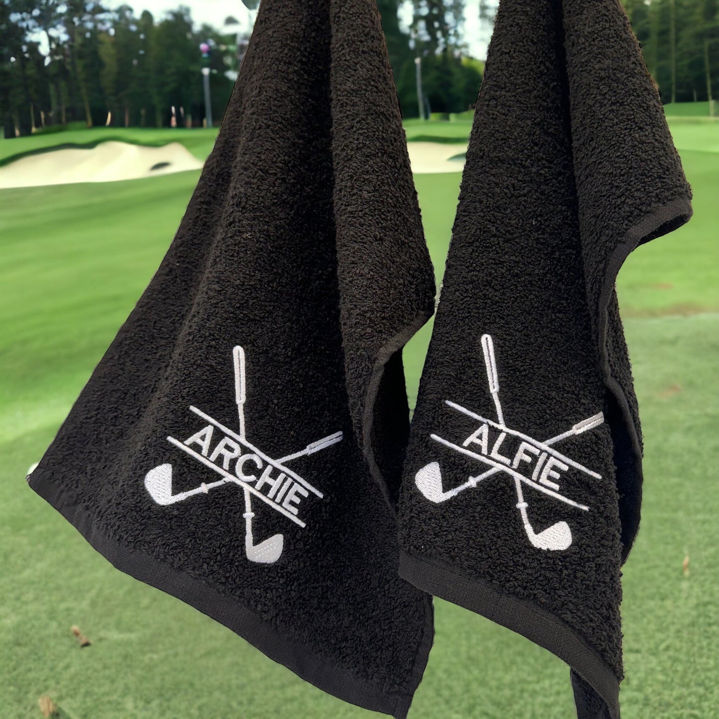 This is a black towel that clips onto your golf cart by a carabiner clip. The towel is embroidered with a golf club monogram and a name through the middle of it. Perfect for wiping those muddy clubs and golf balls down.