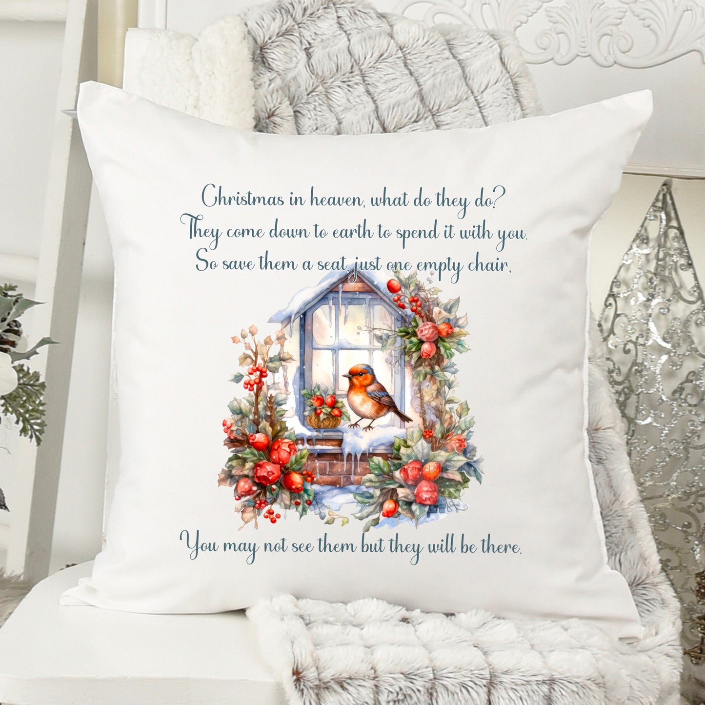 This is a white velvet cushion measuring 40x40cm. Printed on the cushion is a little robin perched on the outside of a window ledge surrounded by holly and berries. A poem accompanies the robin which quotes remembering loved ones at christmas.