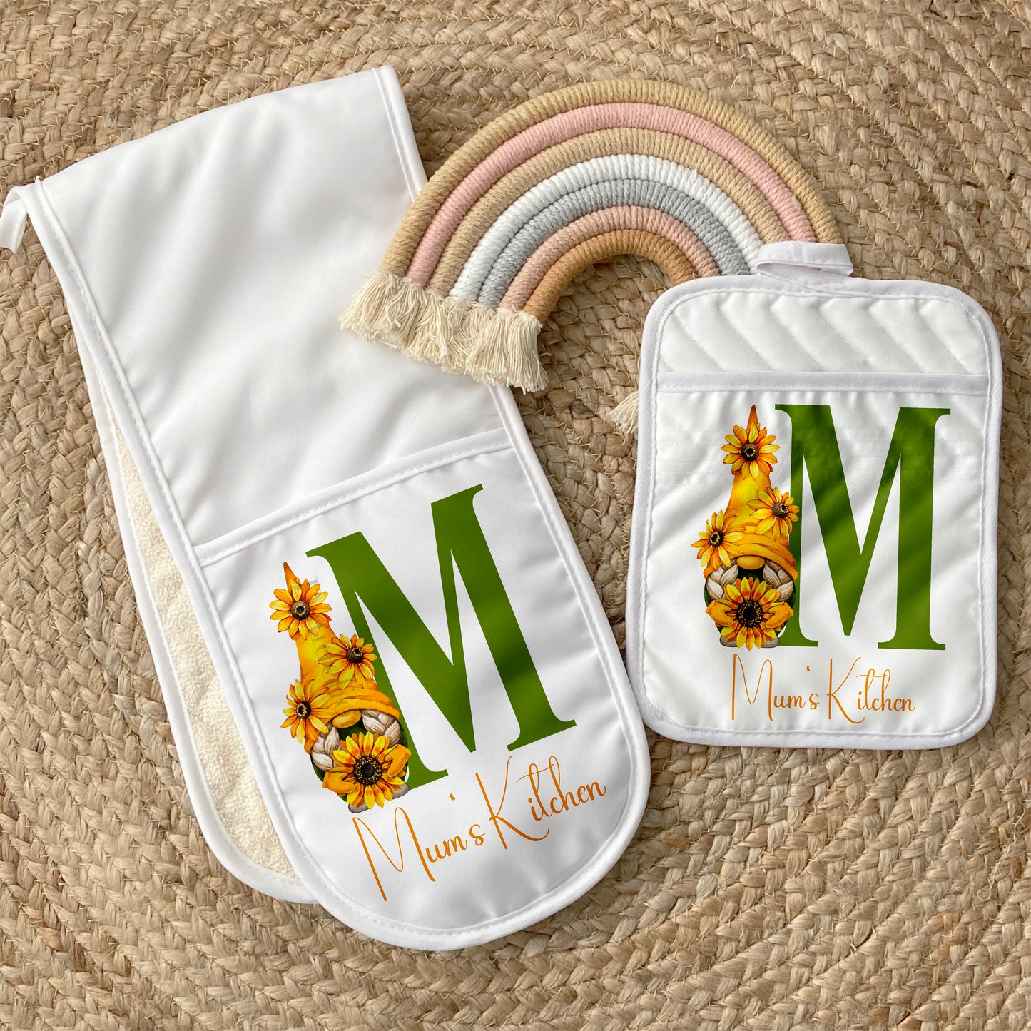 This is an oven glove and a pot mat sitting together. They are both white and printed with a sunflower Gonk next to an initial of your choice. These items have ‘Mums kitchen’ on them. Fantastic gift for a mum, Nan, Gonk or gnome lover.