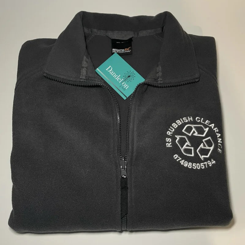This is a grey fleece jacket with long sleeves. Embroidered on the front left breat of the jacket is a business logo. These jackets are suitable for any business large or small