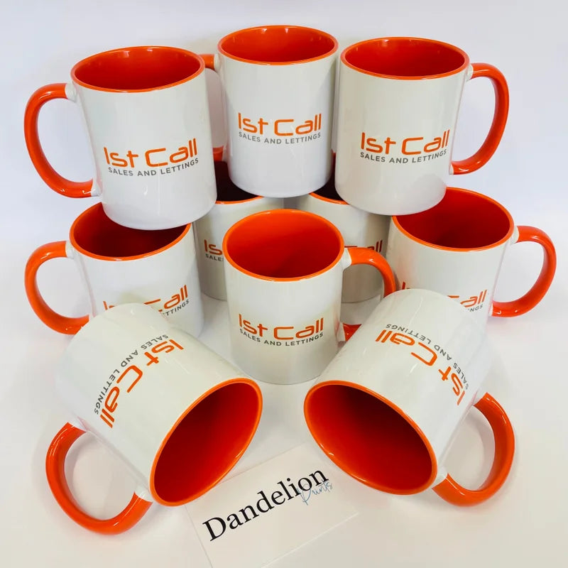 This is a picture of a stack of branded mugs all printed with a company logo. These mugs are available in yellow, orange, pink, light blue, navy blue, light green and red. Branded mugs in the office looks great when clients visit.