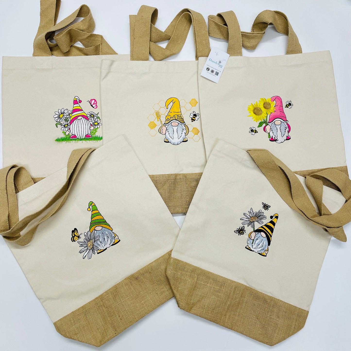 Cotton canvas and jute tote shopping bag. With strong thick jute handles. Each bag has a Gonk/gnome design embroidered. One is a daisy Gonk, one a sunflower Gonk and the other is a honey bee Gonk. These bags are eco friendly and eye catching