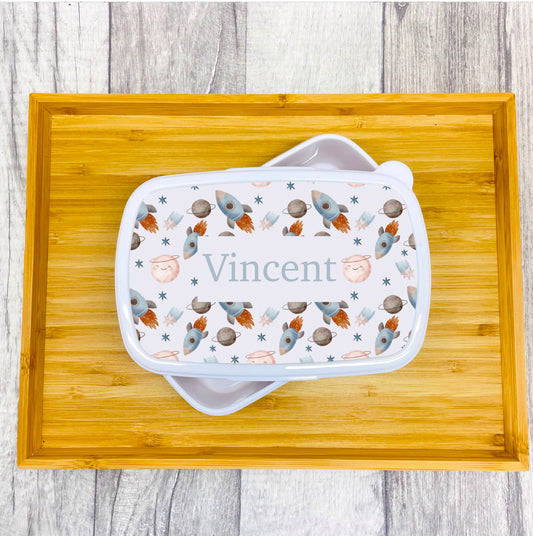 This is a little lunch box perfect for school or nursery. It has a snap shut lid which is printed with a pattern of space objects. These are also personalised with a name so there will be no more missing items at school
