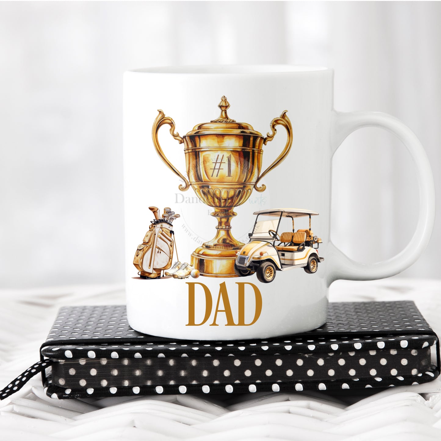 This is a white 11oz mug printed with a number 1 trophy, bag and golf buggy. A name is printed below the gold and cream design.