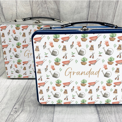 This is a storage tin with a clasp closure. Available in blue or silver these are printed with a full garden tools and accessories design and printed with a name in the middle