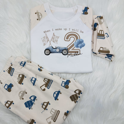 Get your little one ready to race in style with this personalised children's outfit! 
When I wake up, I will be [Big Age Number] years old and ready to hit the road in a cool car adorned with race flags. 
This outfit features a unique printed sleeve design that adds a fun twist to their bedtime routine. 
Perfect for budding racers and car enthusiasts.
These are super soft, long sleeve top and bottom and 100% cotton.

Please take a look at the size guide in the photos before ordering.