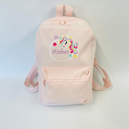 This is a pink girls nursery or school backpack. The backpack is embroidered with a bright unicorn with a hoop and it is also personalised with a name embroidered inside the hoop. These bags are available in many different colours.