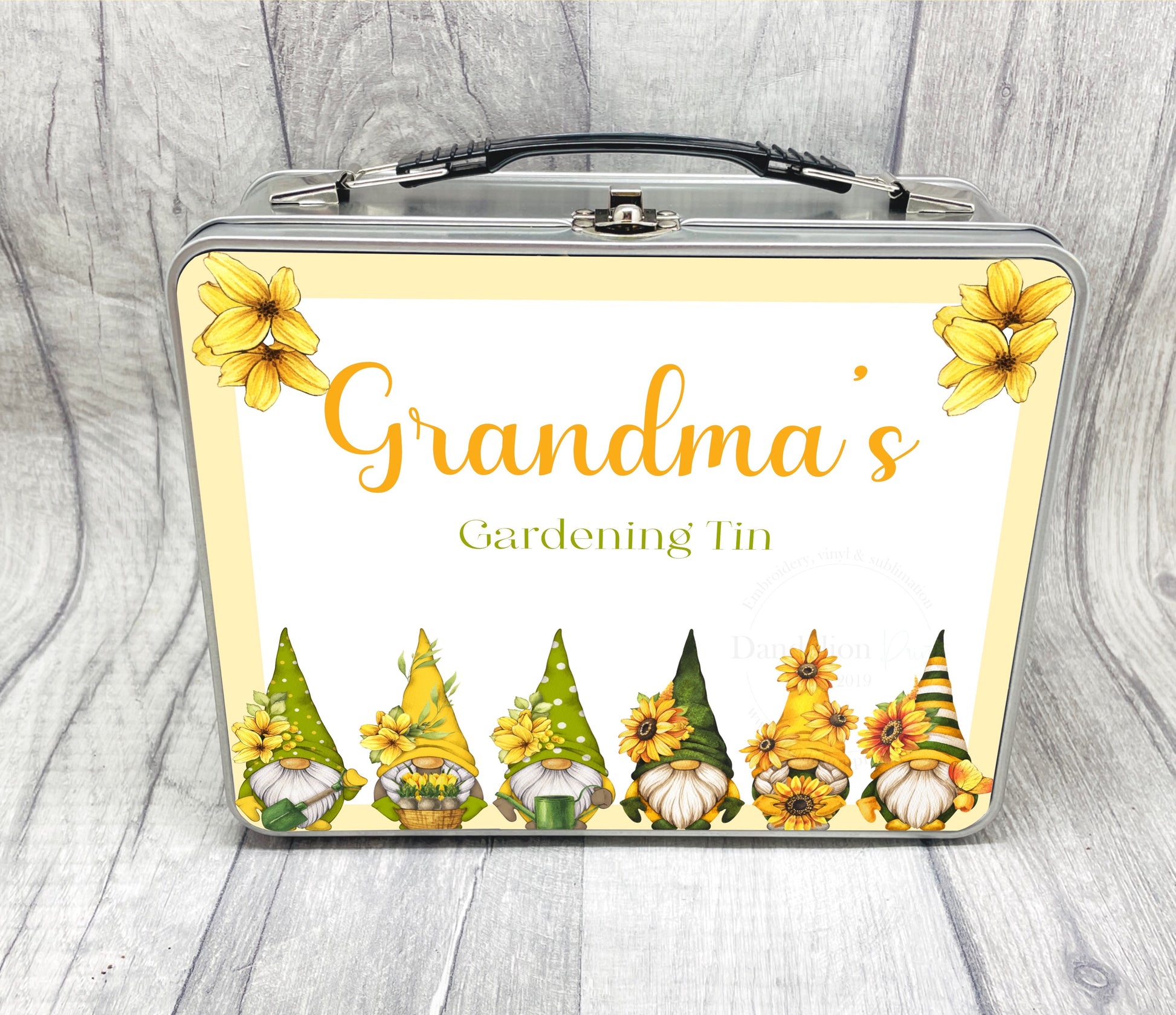 This is a metal briefcase with buckle at the top and a carry handle. Perfect for storing small accessories or gardening tools. Personalised for your recipient this tin has yellow and green gonks lined across the bottom.