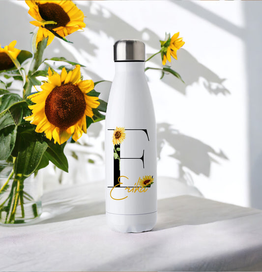 This is a white chill flask. It is designed to keep drinks cooler for longer.  These flasks hold 500ml of liquid. Printed on the flask is a black initial decorated with sunflowers and personalised with a name