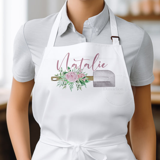 This is a white adults cooking apron printed with a beautiful floral spatula. On top of the spatula is a name printed. Personalised gift for those that love to bake.