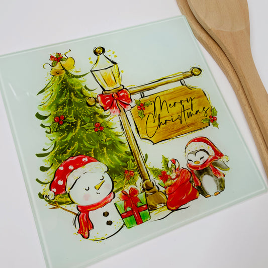 This is a 20cm square glass chopping board. This is printed with a cute christmas friends design featuring a snowman, penguin and a christmas tree. Take christmas into the kitchen with cute accessories