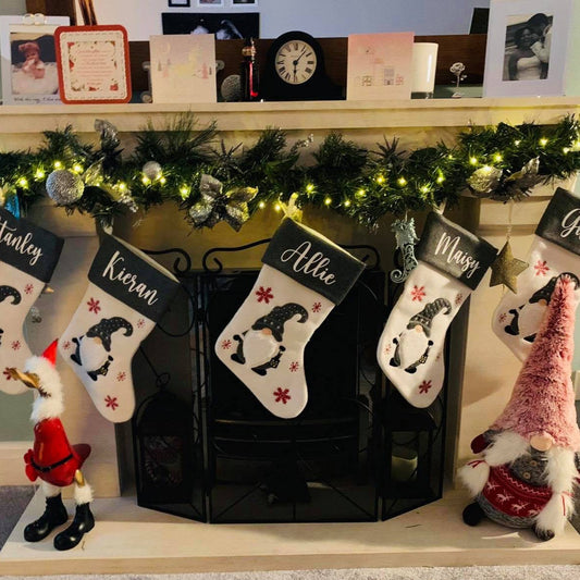 These are deluxe christmas stockings with a cute christmas gnome stitched on the front. The gonk is surrounded by snowflakes and is holding a little lantern. The stocking has a name printed at the top. Add to your decor with a personalised stocking.