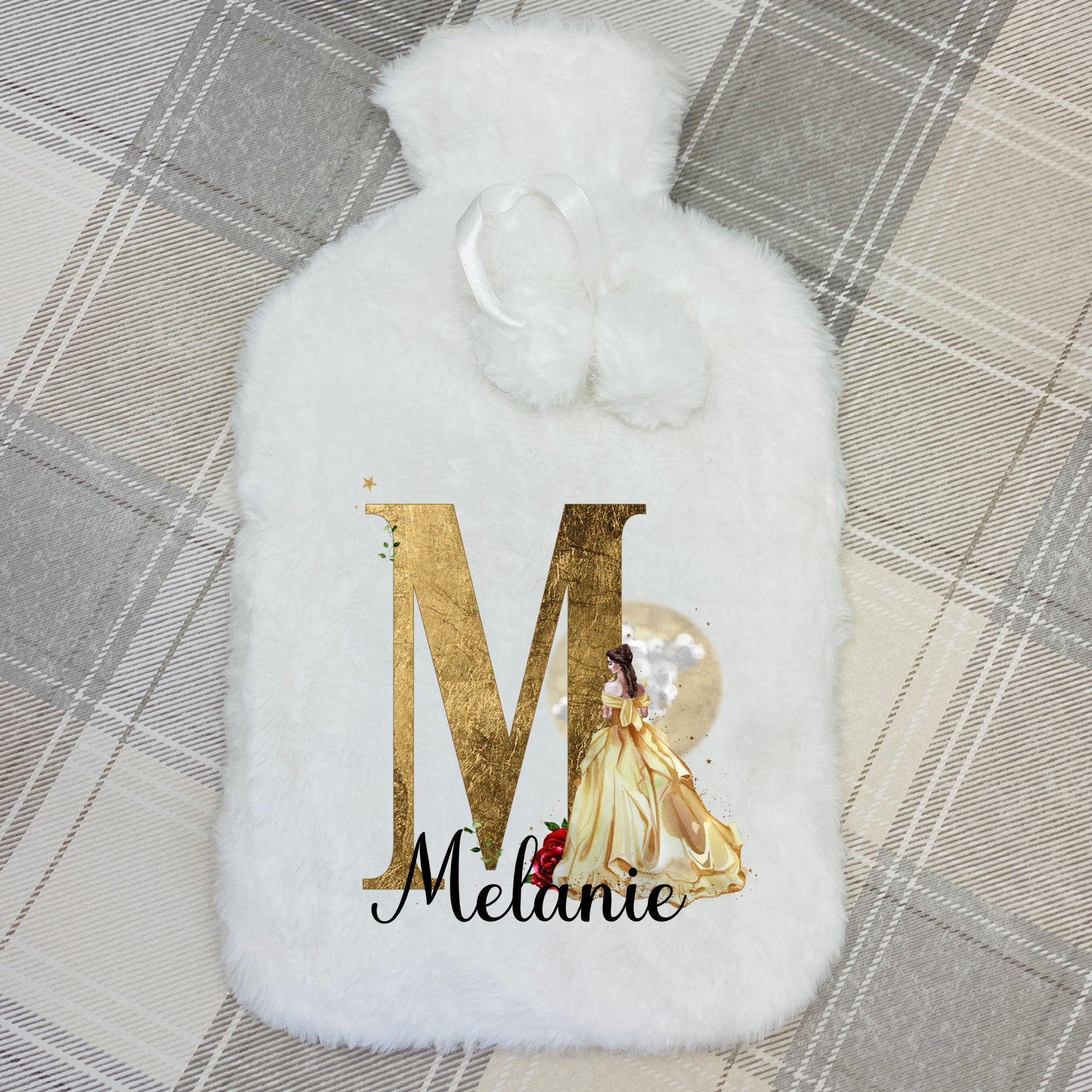 This is a super fluffy white 2  litre hot water bottle and cover. The cover is personalised on the front with a name printed in front of a beautiful golden princess with a gold initial too. This is a perfect gift for any girl.