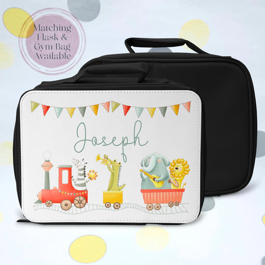 This is a black zip closing childrens lunch bag with a carry handle. The bag is fully insulated to keep lunch food cold. The front of the bag is printed with four zoo animals riding a train playing musical instruments. This also has a name printed above the train.