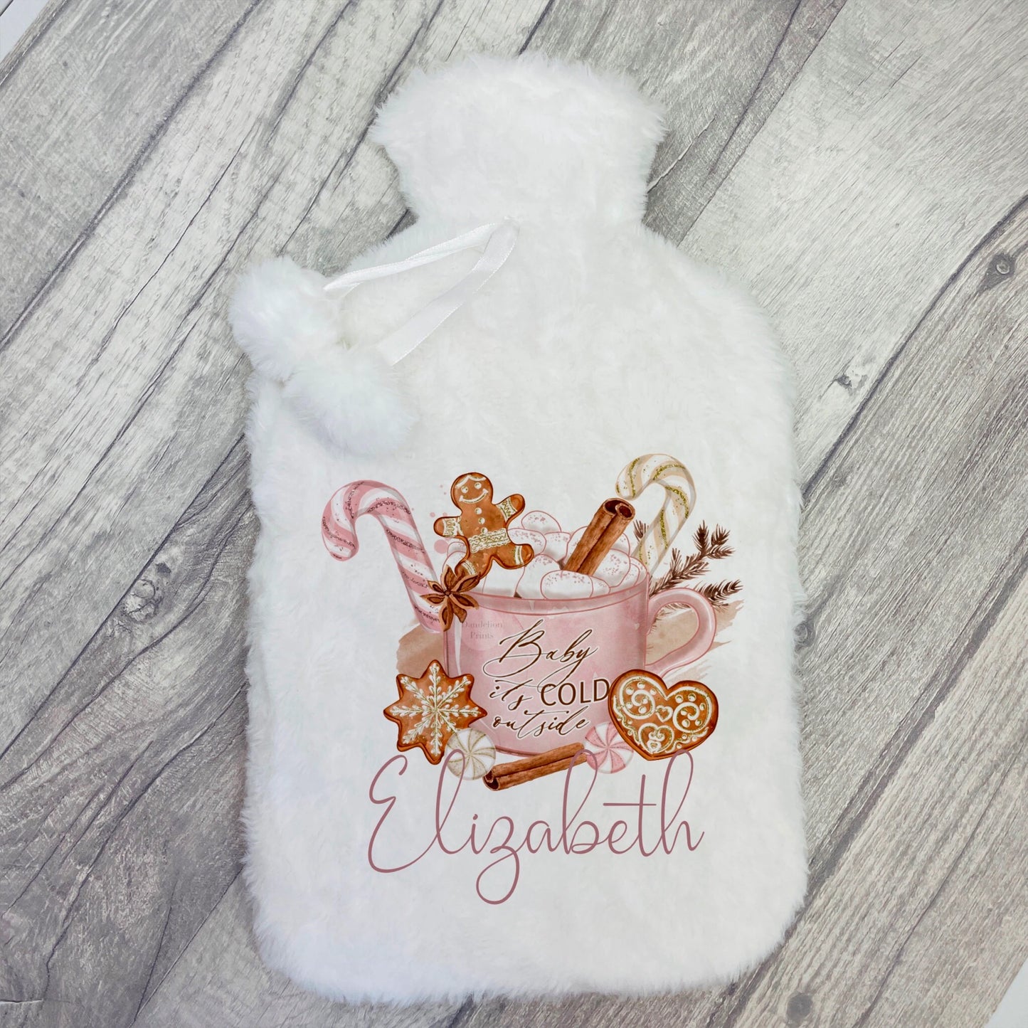 Super soft and fluffy hot water bottle with an image printed on it. The image is of a hot chocolate filled with sweet goodies including a gingerbread man, candy canes, whipped cream, ginger biscuits and cinnamon sticks. Personalised with a name.