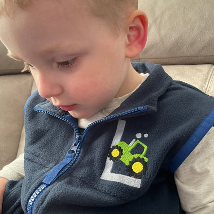 This is a gorgeous little toddler gilet/ fleece body warmer. The fleece is Regatta branded with embroidery of an Initial and a tractor in pink or green with the initial. Great spring clothing