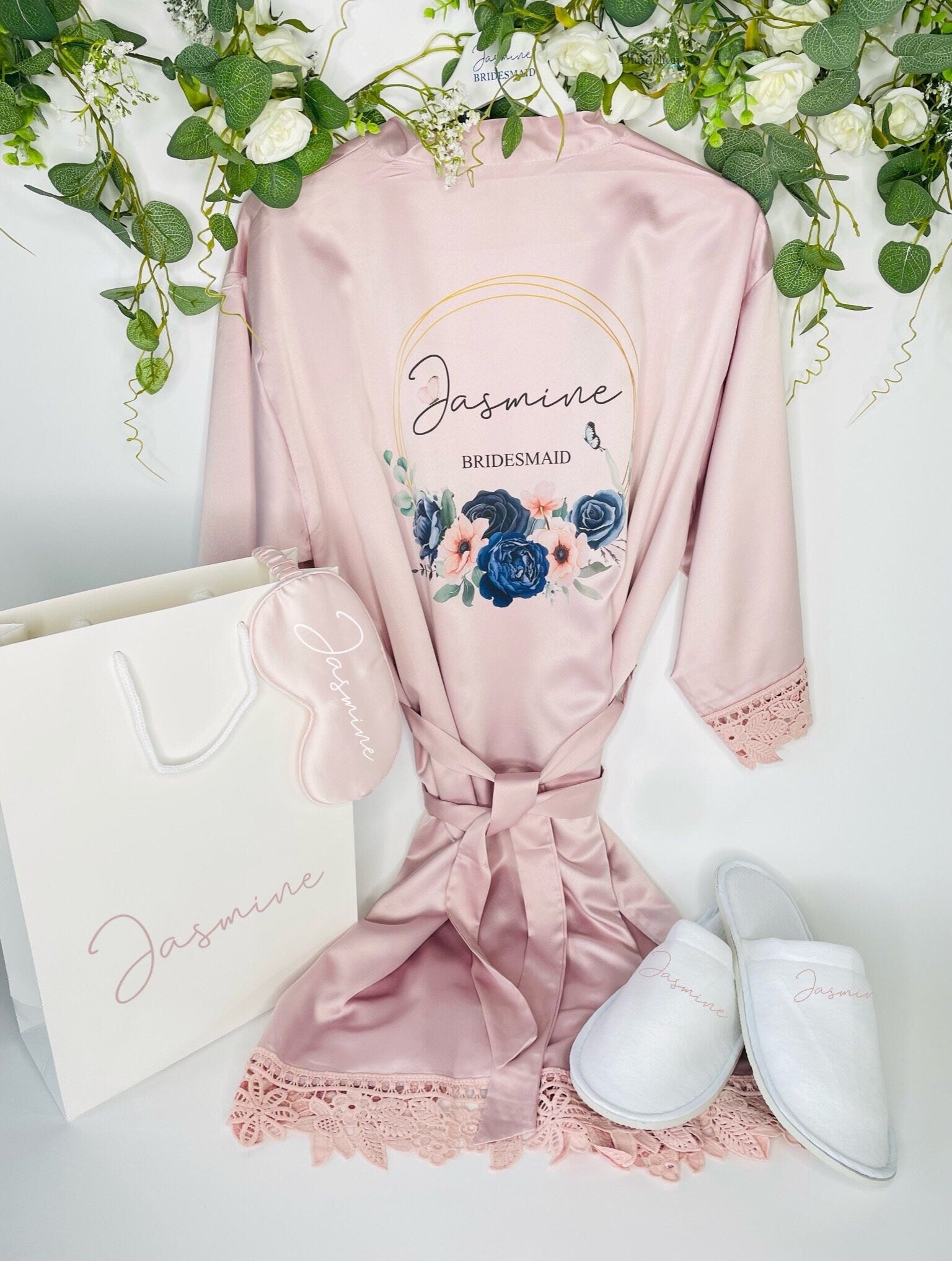 This is a beautiful wedding satin robe printed with a blue and blush hoop with a name inside. Also shown is a white gift bag and slippers both personalised. Your wedding photos will be amazing when youre getting ready in your matching robes.