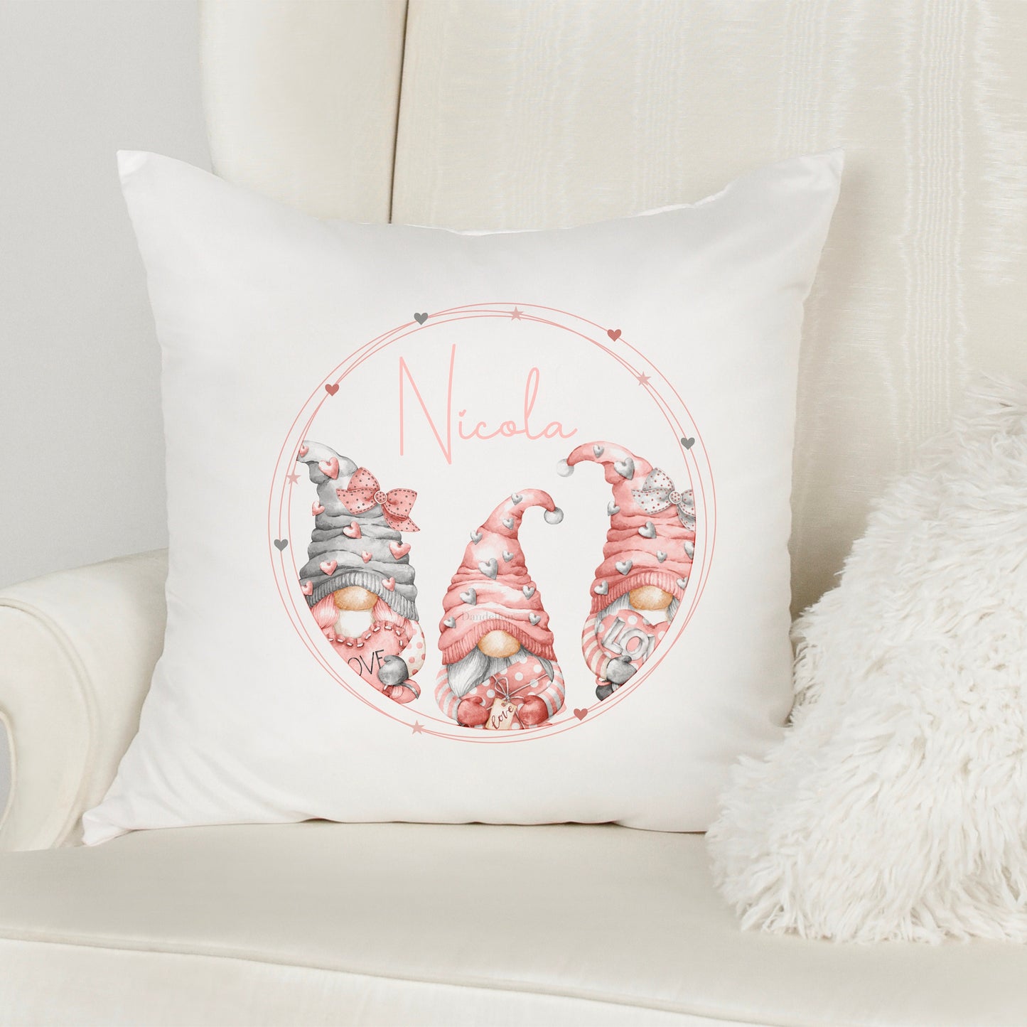 This is a 40x40cm soft white velvet cushion. Printed with three pink gonks in a love heart frame. Inside the frame is a name printed in the middle.