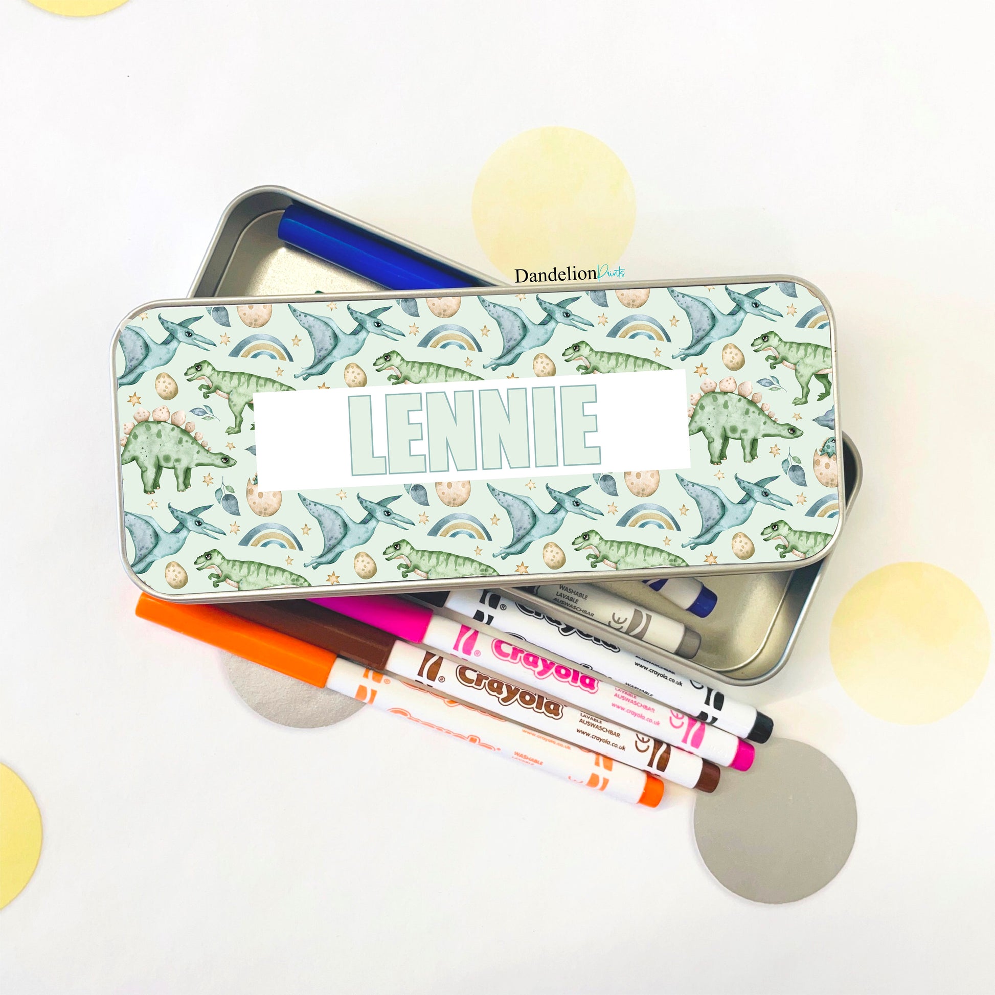 This is a metal pencil tin suitable for children. It is printed with a seamless pattern of dinosaurs and a name in the middle. Little ones will love storing their colouring pens and pencils in their tin